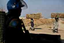 A police officer from Rwanda working under the auspices of Unmiss, the UN mission in South Sudan, stands guard at the entrance of Malakal camp. The prevalence of sexual assaults on women who go to collect firewood outside the camp has led UN peacekeepers to carry out regular armed patrols, securing the ground ahead of them. One UN survey found 70% of women in camps such as Malakal said they had been raped since conflict erupted in December 2013